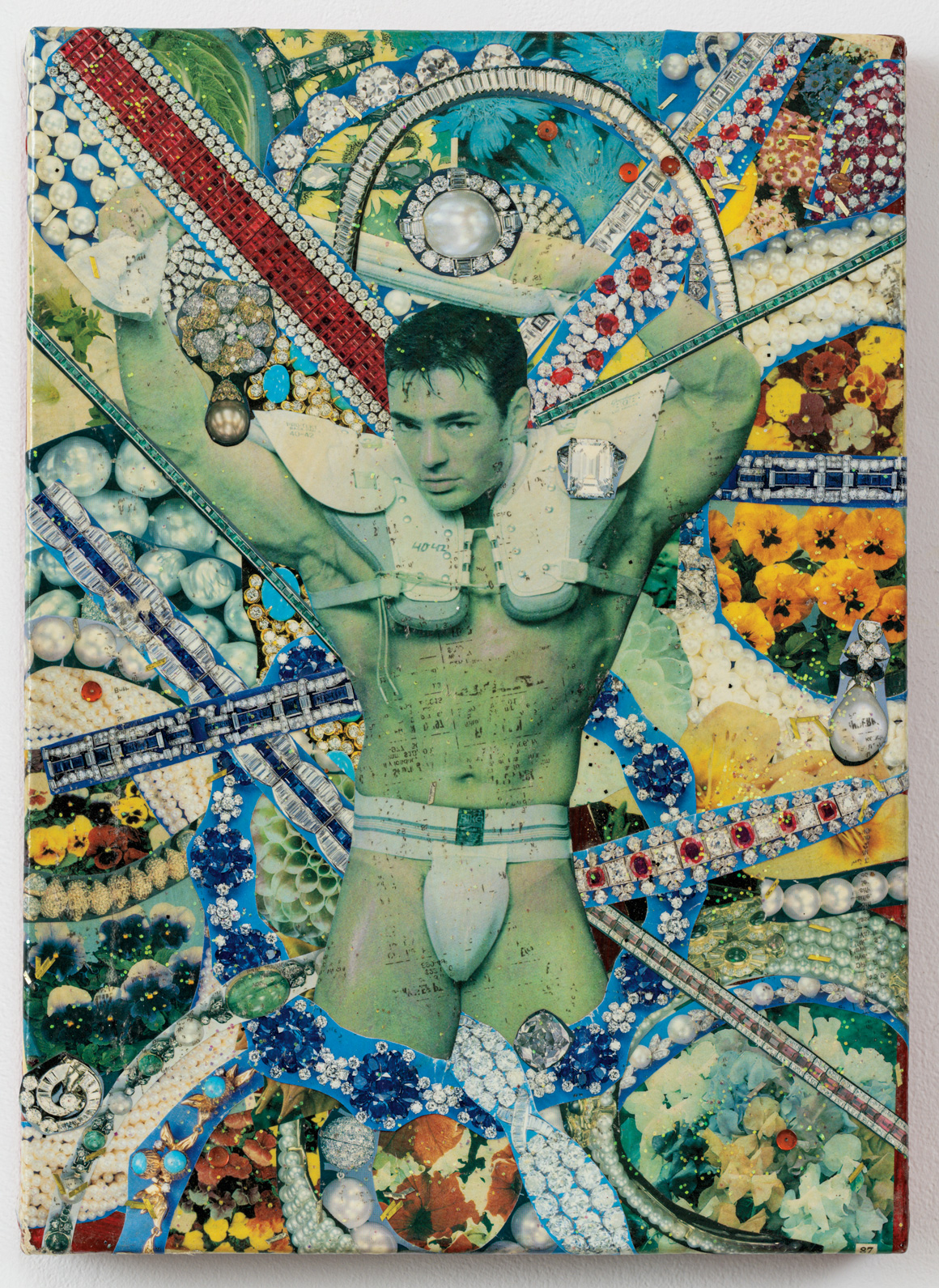 A green-toned figure with outstretched arms surrounded by colorful flowers, jewel-like patterns, pearls, and vibrant overlapping geometric designs.