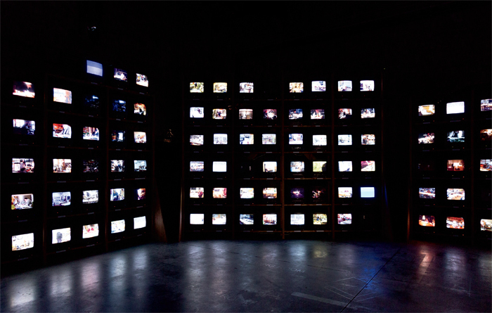 Dieter Roth, Solo Szenen (Solo Scenes), 1997–98, 131 video monitors, media players, shelving. Installation view, Arsenale, Venice, 2013. From “The Encyclopedic Palace.” Photo: Kate Lacey. © Dieter Roth Estate.