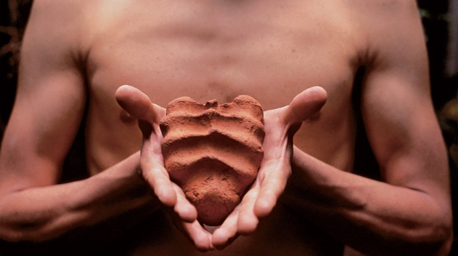 Gabriel Orozco, Mis manos son mi corazón (My Hands Are My Heart), 1991, diptych, two Cibachrome prints, each 9 1⁄8 × 12 1⁄4". A shirtless figure holds a clay object in both hands, first tightly clasped, then displayed openly, revealing its heart-like shape and textured surface.