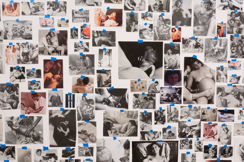A collage of vintage and contemporary photos showing childbirth, pregnancy, and infant care, arranged on a wall with blue tape. Carmen Winant, My Birth (detail), 2018, 3,059 found paper and photographic prints, painter’s tape, dimensions variable.