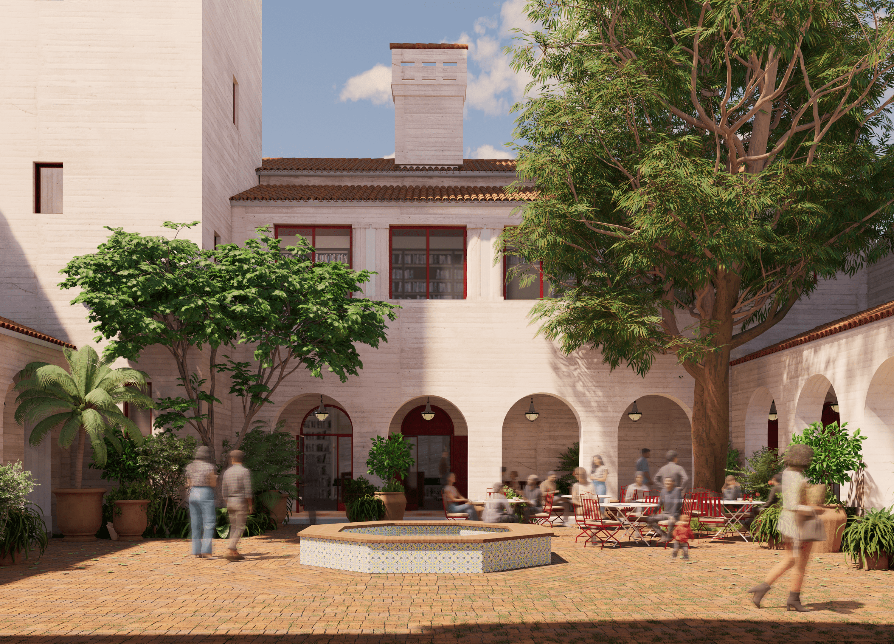 A sunny courtyard surrounded by light-colored buildings with red-tiled roofs and arched openings. The space is decorated with potted plants and trees, including a large central tree and a tiled fountain. People are walking and sitting at red tables, enjoying the calm atmosphere.